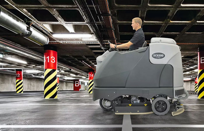 Advance rider floor scrubber in parking garage
