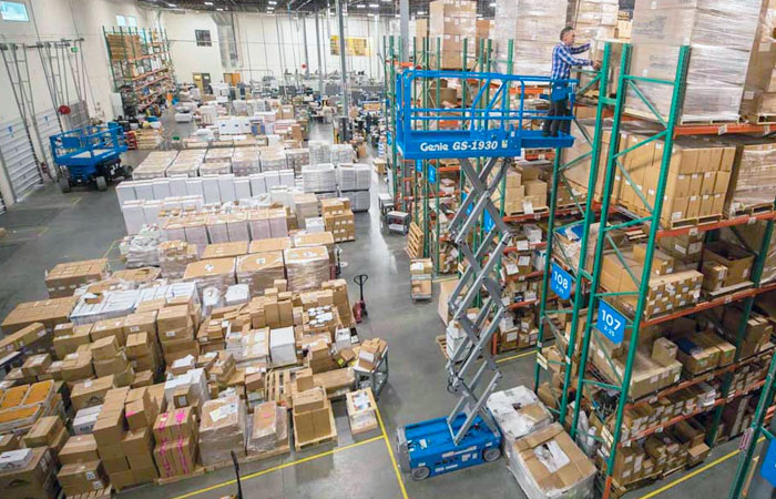 Aerial view of an extended Genie scissor lift in warehouse