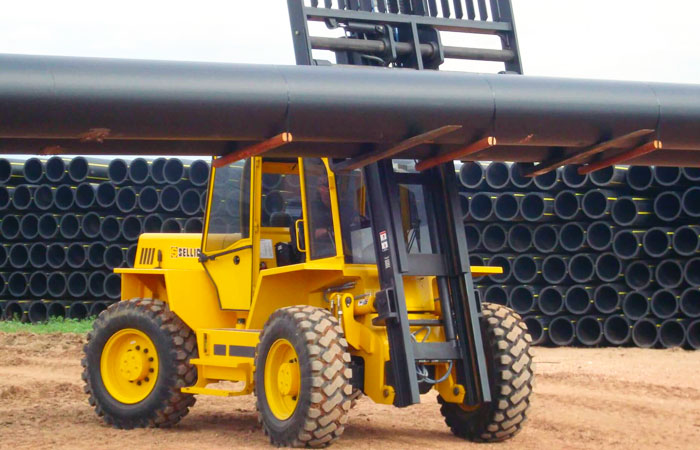 sellick rough terrain forklift carrying a long good