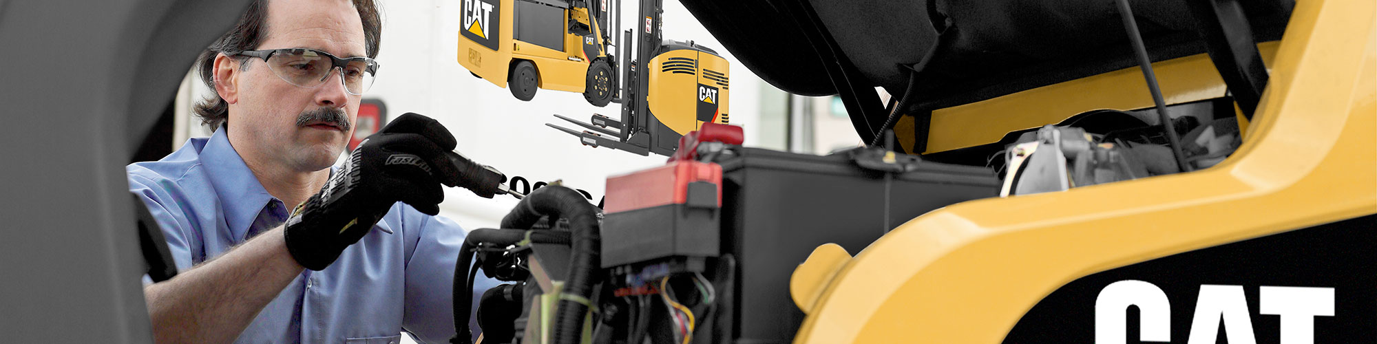 Service technician working on a CAT forklift