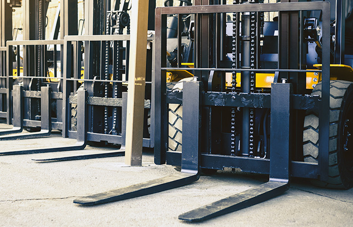 line of a bunch of forklift forks