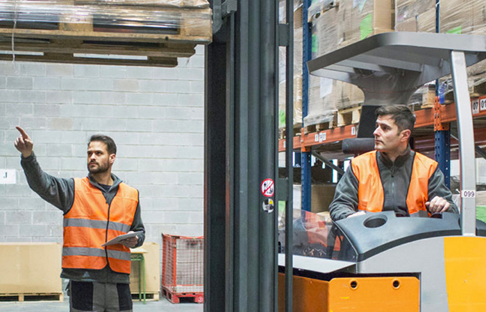 Two men and a forklift doing training