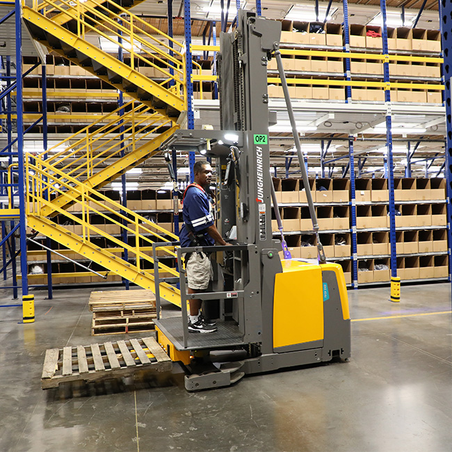 Man on Jungheinrich forklift in warehouse