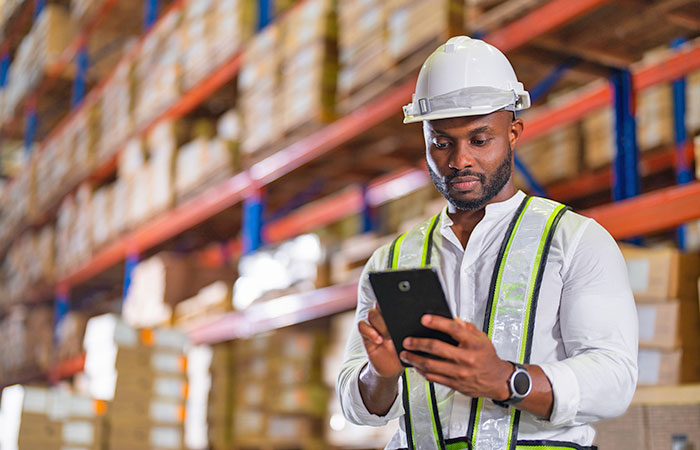 Man in warehouse on tablet