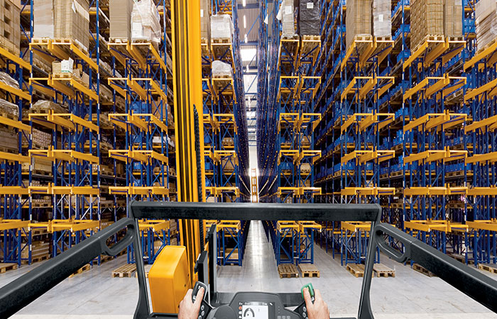 Forklift driving into pallet rack